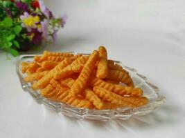 Spicy Prawn Crackers in a transparent container isolated on a white background photo