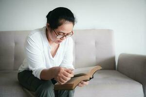 asiático mujer leyendo el Biblia. hembra manos Orando a dios. mendicidad para perdón y creer en bondad. cristiano vida crisis oración a dios. orar para Dios bendición a deseando tener un mejor vida. foto