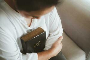 Asian woman reading the bible. Female hands praying to god. Begging for forgiveness and believe in goodness. Christian life crisis prayer to god. Pray for god blessing to wishing have a better life. photo