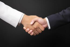 Business agreement handshake hand gesture on dark background. photo