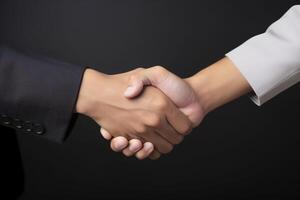 Business agreement handshake hand gesture on dark background. photo