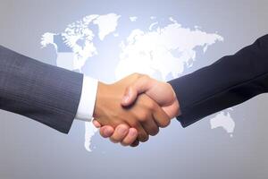 Business agreement handshake hand gesture with a world map in the background. photo