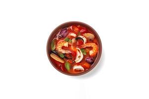 Delicious a bowl of Thai soup Tom Yam Kung with shrimps and clams isolated on white background. photo