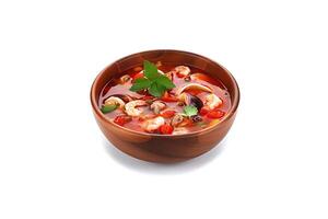 Delicious a bowl of Thai soup Tom Yam Kung with shrimps and clams isolated on white background. photo