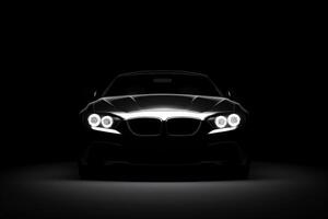 Front view dark silhouette of a modern luxury black car isolated on black background. photo