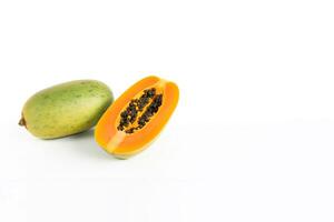 Fresh whole and sliced papaya fruits isolated on white background with copy space. photo