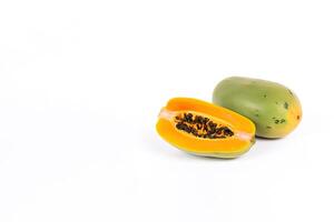 Fresh whole and sliced papaya fruits isolated on white background with copy space. photo