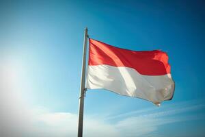 Indonesia nacional bandera ondulación en azul cielo. rojo y blanco bandera con nubes ai generado foto