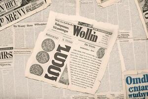 An old vintage newspaper pieces background. photo