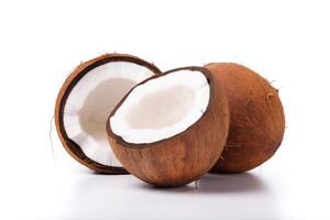 a whole and a half coconut on a white surface. photo