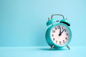 blue alarm clock on a blue background. photo