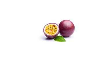Fresh whole and sliced purple passion fruits isolated on white background with copy space. photo