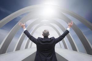 Successful businessman raising hand and expressing positivity while standing over the bridge. photo