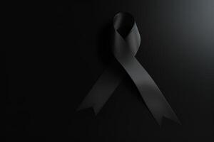 Black mourning ribbon with a dark background. photo