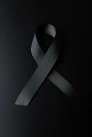 Black mourning ribbon with a dark background. photo