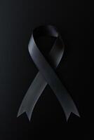 Black mourning ribbon with a dark background. photo