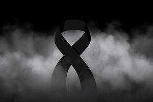 Black mourning ribbon with a dark smoke background. photo