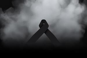 Black mourning ribbon with a dark smoke background. photo