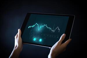 Business person analyzing stock market data on tablet with dark background. photo