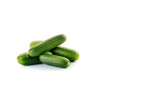 A pile of fresh green cucumbers isolated on white background with copy space. photo