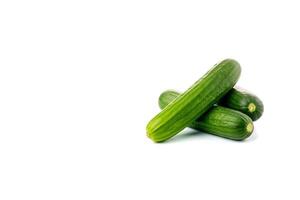 A pile of fresh green cucumbers isolated on white background with copy space. photo