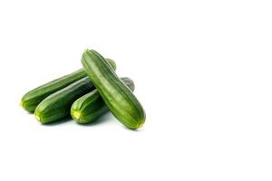 A pile of fresh green cucumbers isolated on white background with copy space. photo