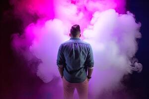 a man standing in front of a cloud of smoke with neon lights. photo