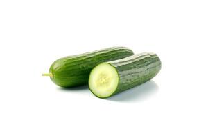 A pile of fresh whole and sliced green cucumbers isolated on white background. photo