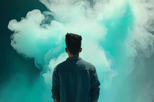 a man standing in front of a cloud of smoke with the cyan theme. photo