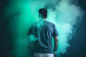 a man standing in front of a cloud of smoke with the cyan theme. photo