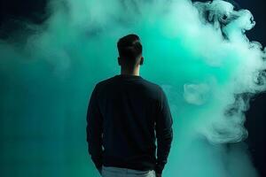 a man standing in front of a cloud of smoke with the cyan theme. photo