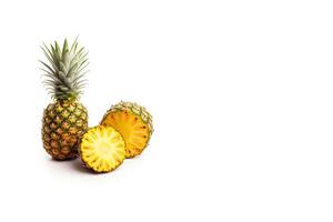 Fresh ripe whole and sliced pineapples isolated on white background with copy space. photo