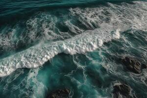 Aerial view of waves crashing against the rocks in the ocean. photo