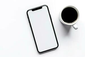 Smartphone with blank screen and cup of coffee on white background. photo