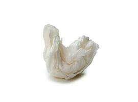 Single white screwed or crumpled tissue paper or napkin in strange shape after use in toilet or restroom isolated on white background with clipping path photo