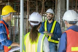 Team of engineer, architect, contractor and foreman meeting and consulting in construction building site for inspection in real estate development project industry and specification quality control photo