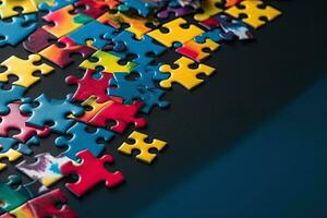 Colorful jigsaw puzzle pieces on a blue background with copy space photo