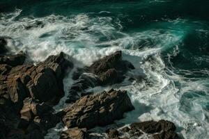 Aerial view of waves crashing against the rocks in the ocean. photo