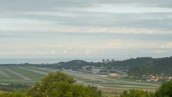 Time lapse of traffic at the airport, panoramic view of the airfield. Clouds float over the city video