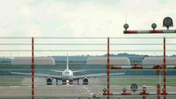 Front view of the braking aircraft. Runway at Dusseldorf with an unidentified passenger plane video