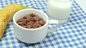 Chocolate corn flakes in a bowl on table video