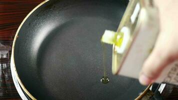 Putting olive oil in a cooking pan top view video