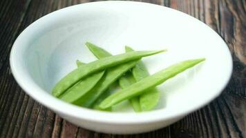 Putting holland beans in a bowl on table video