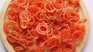 Slow motion of jalebi indian sweet drops on a plate video
