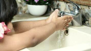 Child washing hands with soap isolated on black video