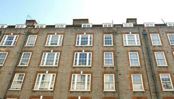 Exterior of modern brick house object. Architectural detail of a skyscraper, close-up on the windows. Real estate, residential apartments and offices. Living apartments or office building architecture photo