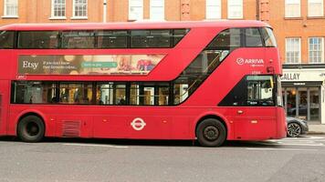 Famous Red Double Decker Bus in the center of the city London - January, 2023. Double-decker buses are in common use throughout the United Kingdom. photo