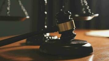 Justice and law concept.Male judge in a courtroom with the gavel, working with, computer and docking keyboard, eyeglasses, on table in morning light video