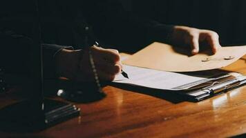 Business and lawyers discussing contract papers with brass scale on desk in office. Law, legal services, advice, justice and law concept picture with film grain effect video