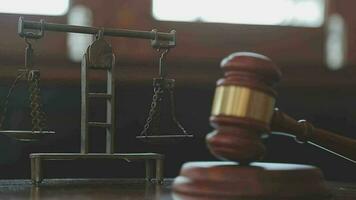 Justice and law concept.Male judge in a courtroom with the gavel, working with, computer and docking keyboard, eyeglasses, on table in morning light video